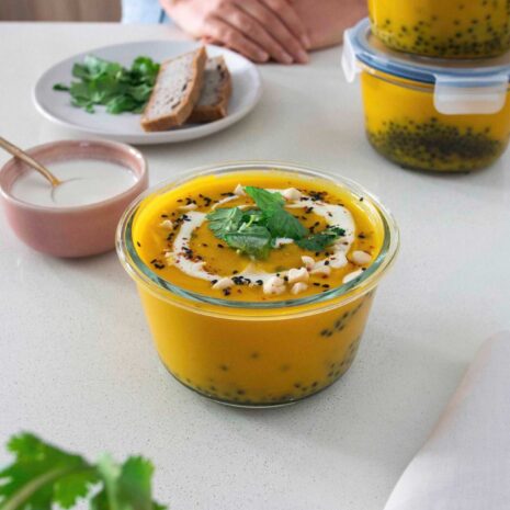 Carrot ginger and lentil soup in containers, a perfect meal-prep option.