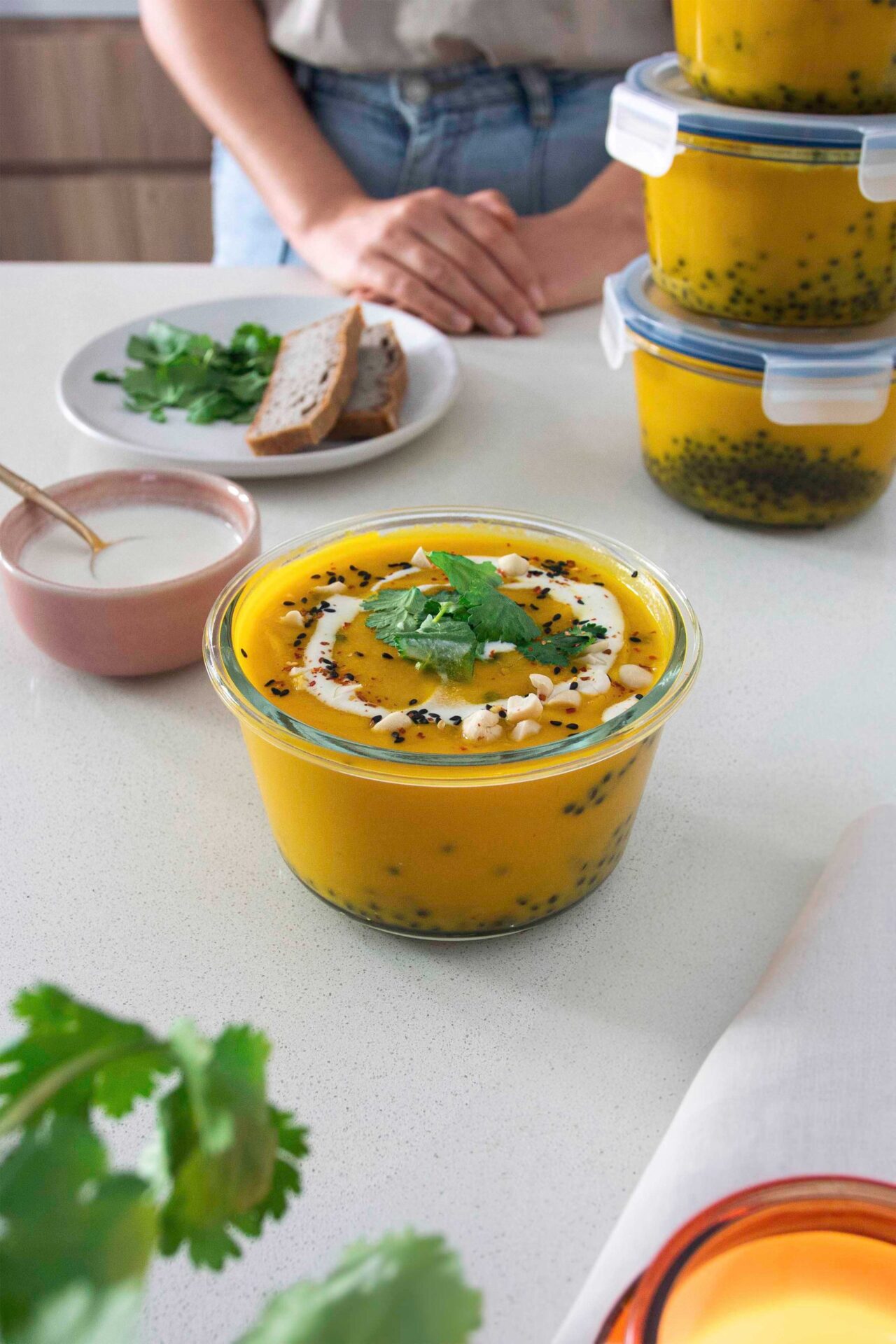 Carrot ginger and lentil soup in containers, a perfect meal-prep option.
