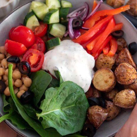 A beautifully arranged bowl filled with vibrant and colorful ingredients inspired by Greek mythology. This Greek Goddess Bowl features a bed of fluffy quinoa topped with fresh and crisp cucumber slices, juicy cherry tomatoes, creamy feta cheese, tangy Kalamata olives, and a sprinkle of fragrant herbs. Drizzled with a zesty lemon dressing, this bowl is a divine combination of flavors and textures that will transport you to the Mediterranean.