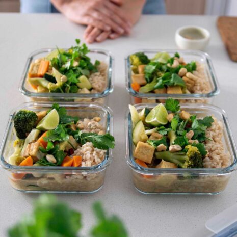 A vibrant and aromatic vegan Green Thai Curry in multiple meal prep containers