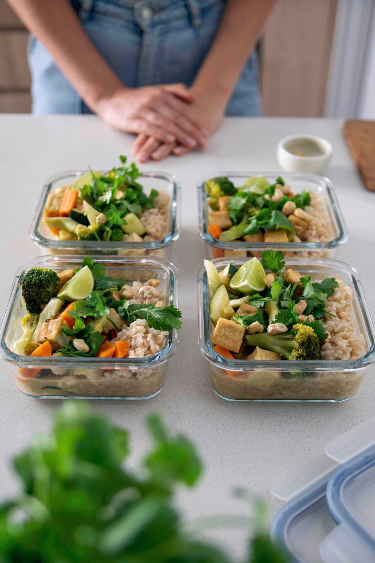 A vibrant and aromatic vegan Green Thai Curry in multiple meal prep containers