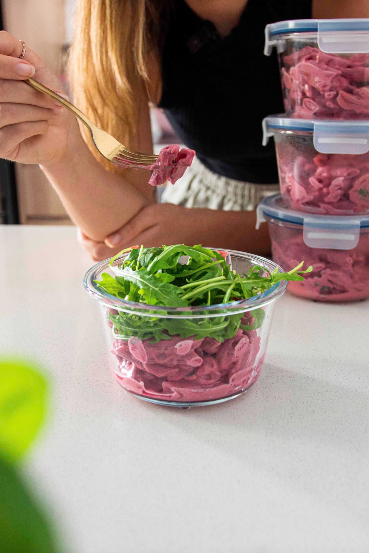 High-protein pink pasta in a container for meal prep