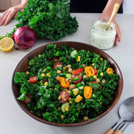 Big salad bowl of Kale Chickpea Salad with healthy ranch dressing