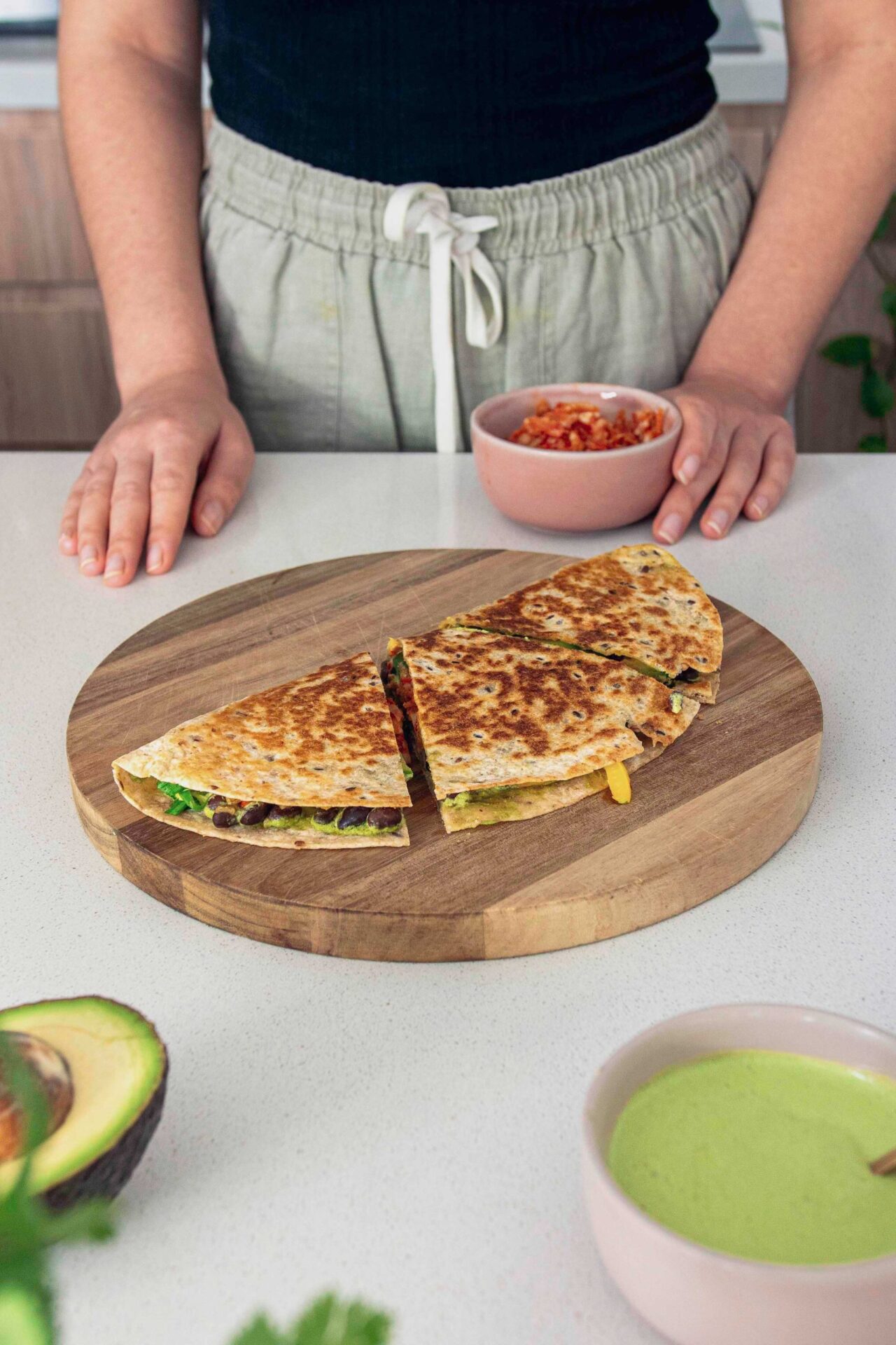 Kimchee quesadilla, cut on a chopping board