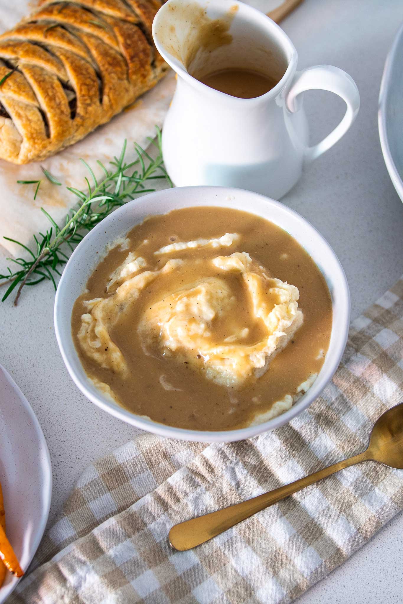 Holiday vegan mashed potatoes and mushroom gravy served in a white bowl