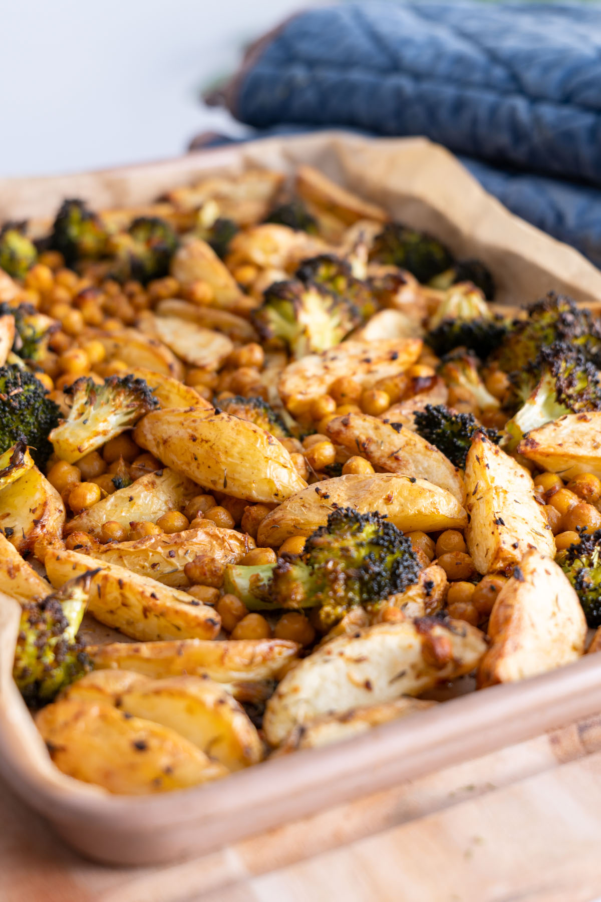 A tray of roasted potatoes, broccoli, and chickpeas fresh out of the oven.