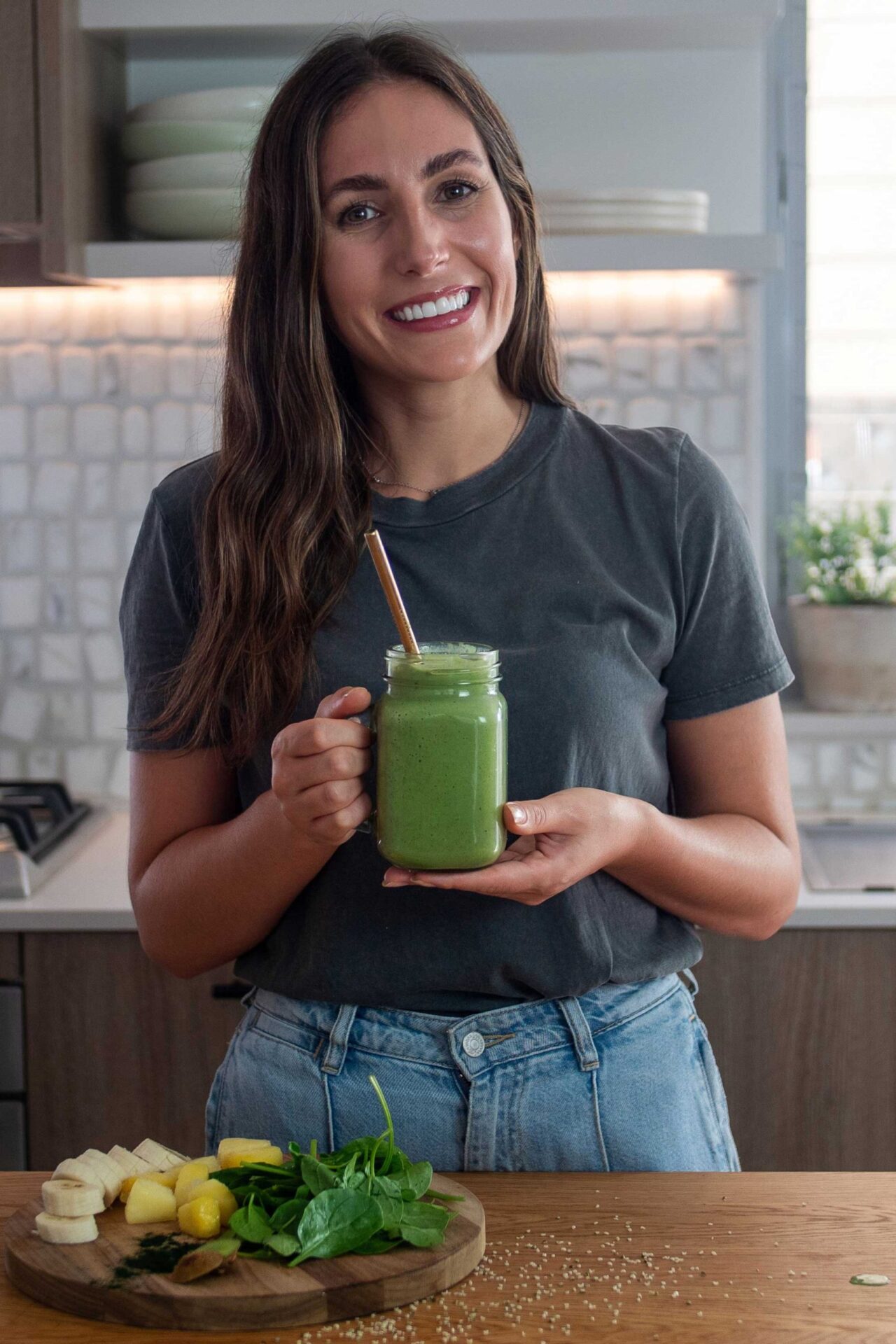Sarah of plantbaes with a vibrant green smoothie for women's health