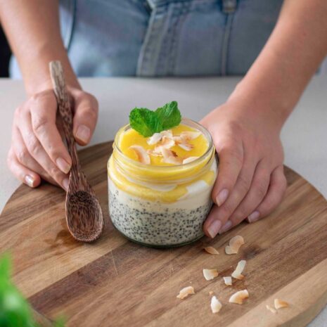 Pina colada chia pudding topped with fresh pineapple and coconut flakes