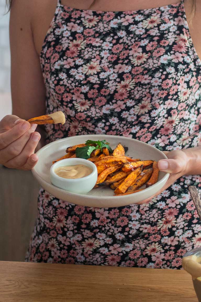 A mouthwatering image of creamy and flavorful cashew queso, perfect for dipping sweet potatoes or drizzling over nachos.