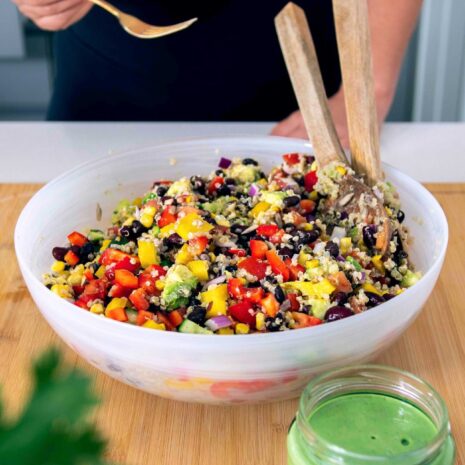 Colorful and nutritious rainbow quinoa salad with a variety of fresh vegetables and a tangy dressing.