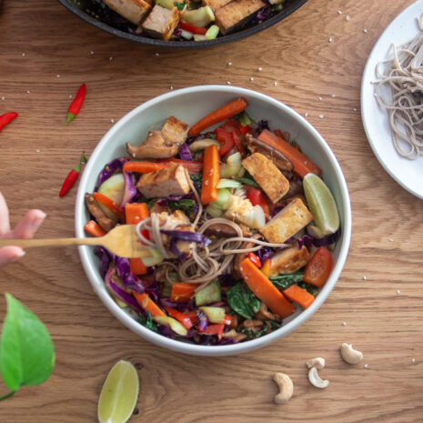 Big bowl of a rainbow coloured stirfry with noodles