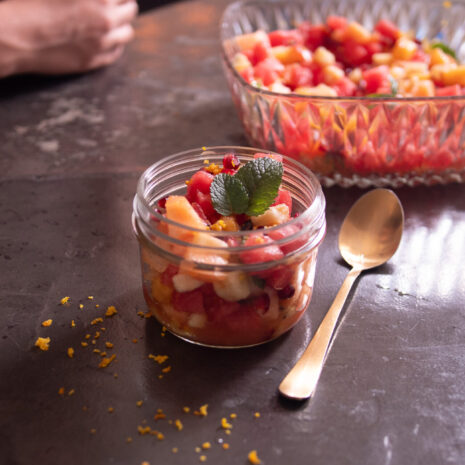 Refreshing vibrant jar full of colourful summer fruit salad