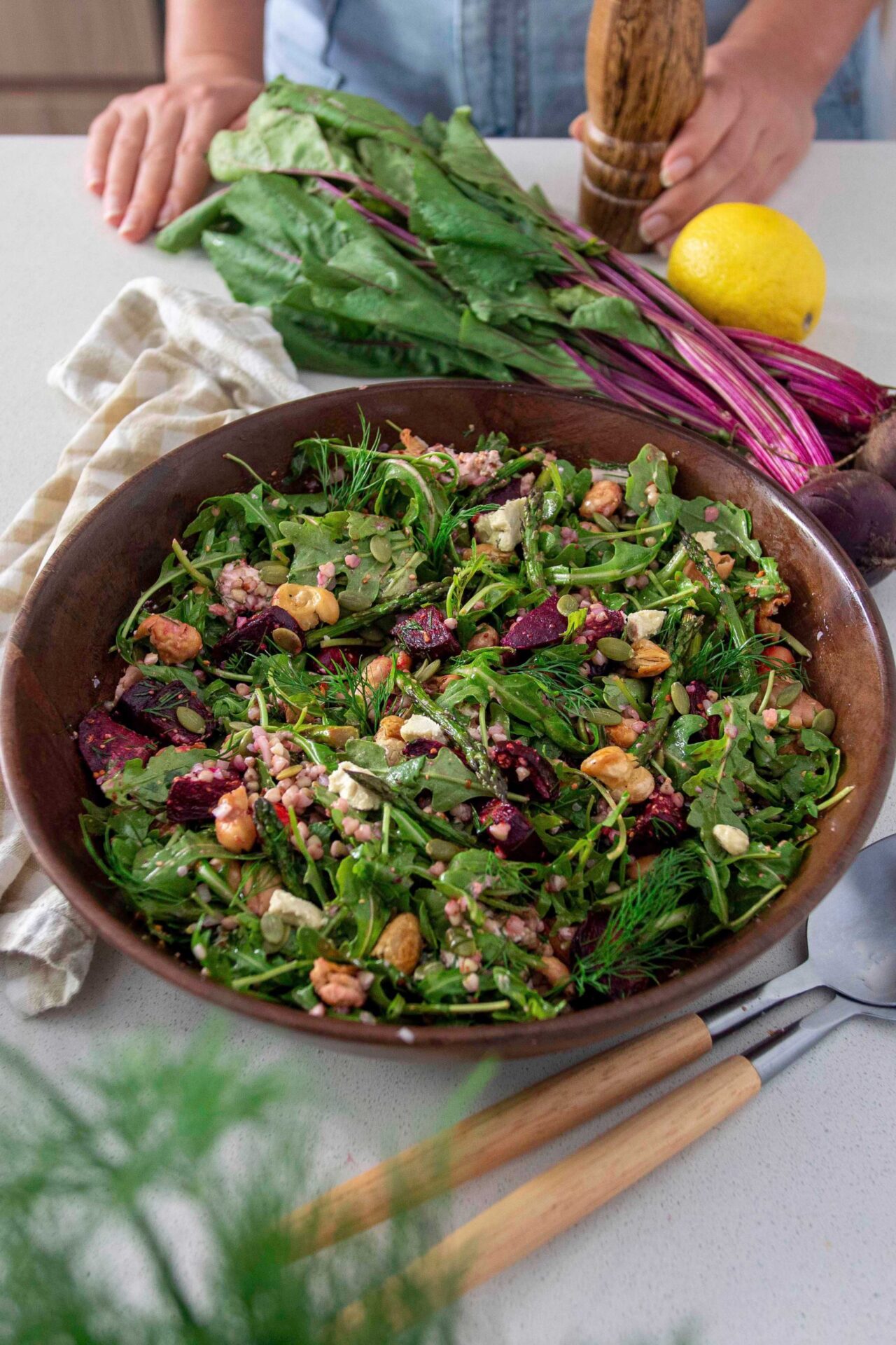 Roasted asparagus beetroot and butter bean salad in a wooden salad bowl