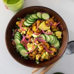 Vibrant, healthy roasted cauliflower and avocado salad in a wooden salad bowl