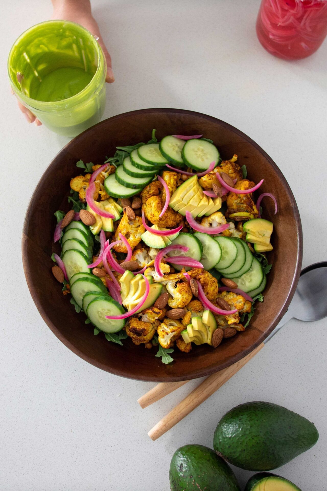 Vibrant, healthy roasted cauliflower and avocado salad in a wooden salad bowl