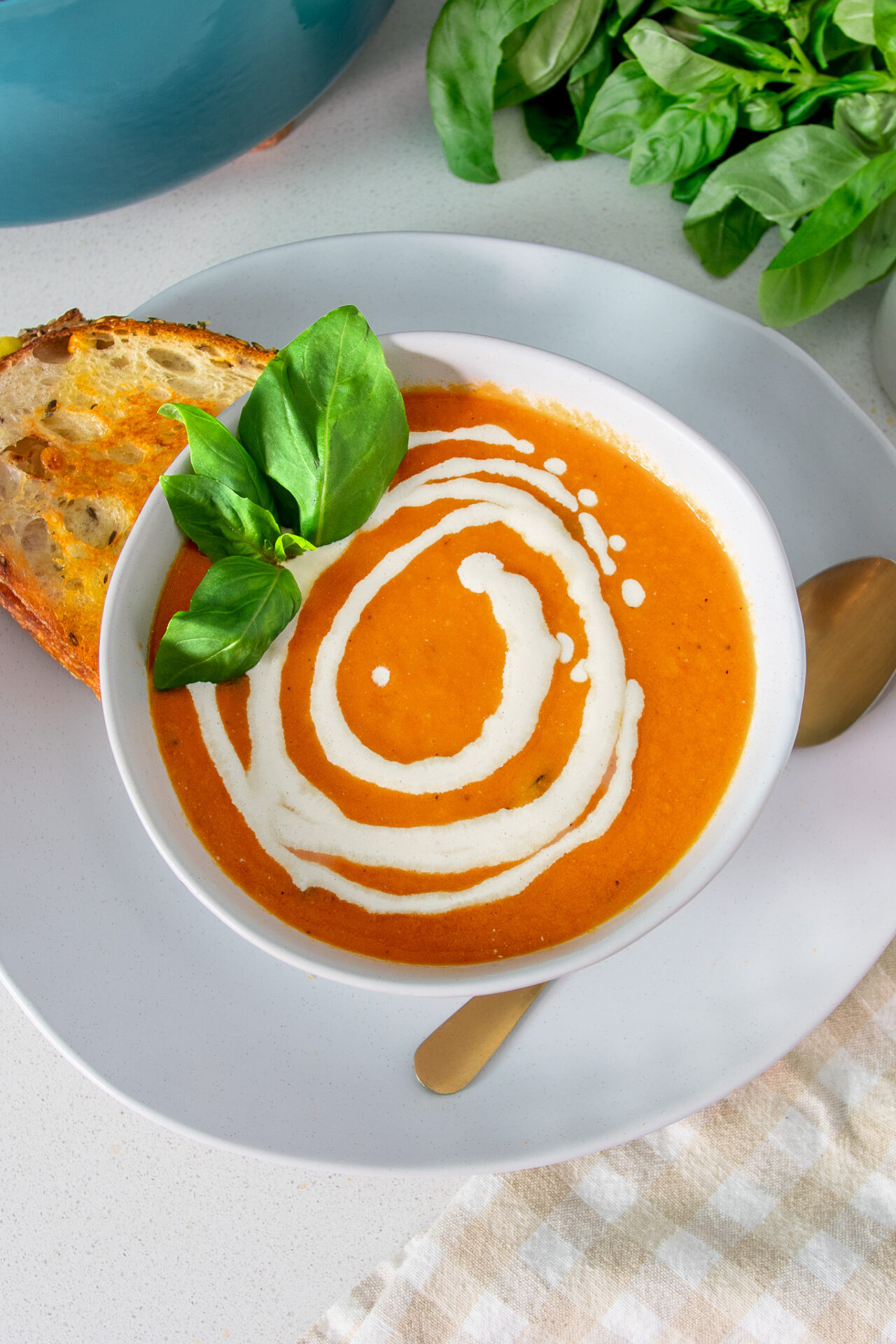 Vibrant bowl of roasted tomato soup with sourdough for dipping