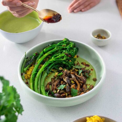 Shredded mushrooms with coriander dip and broccolini in a large bowl