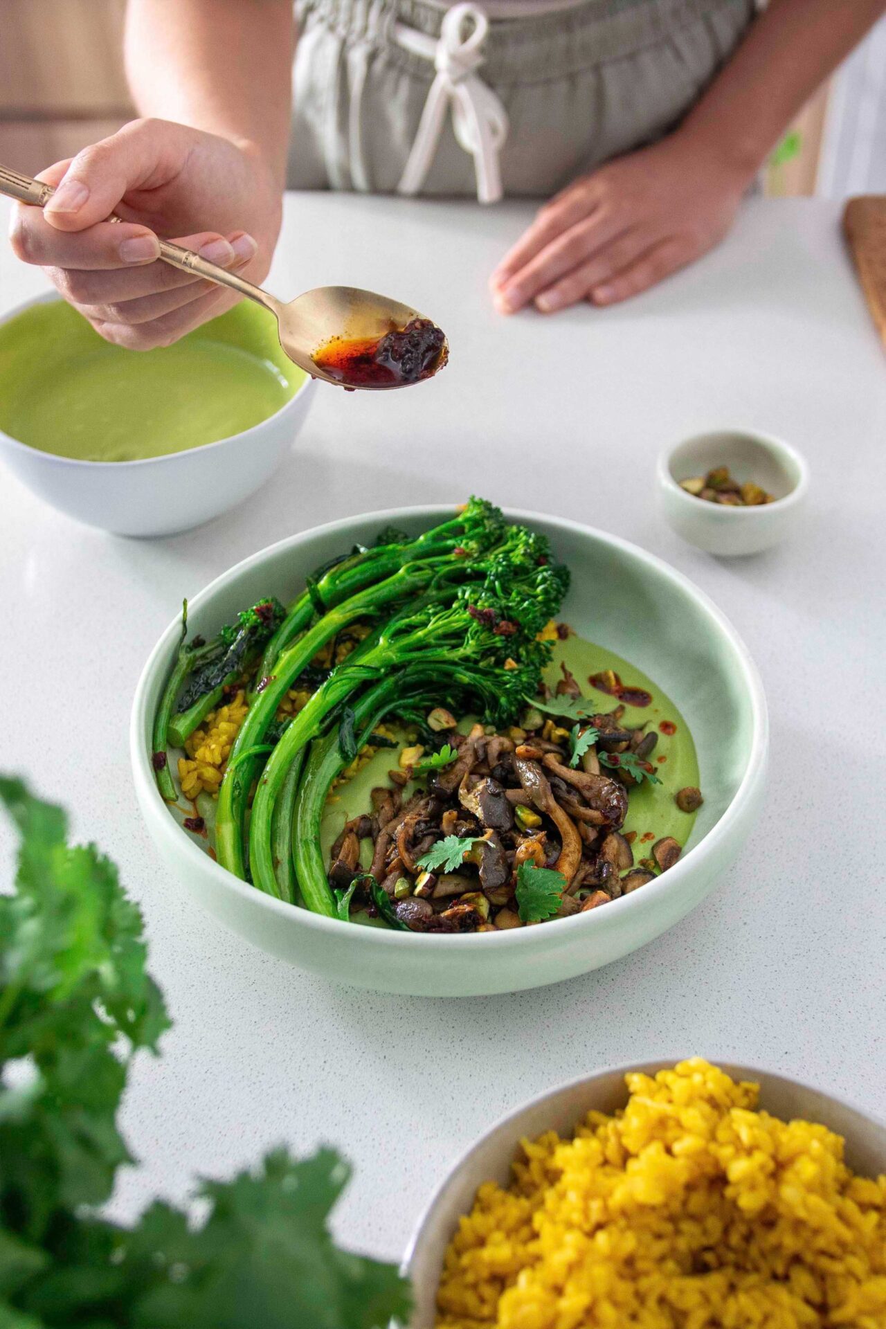 Shredded mushrooms with coriander dip and broccolini in a large bowl