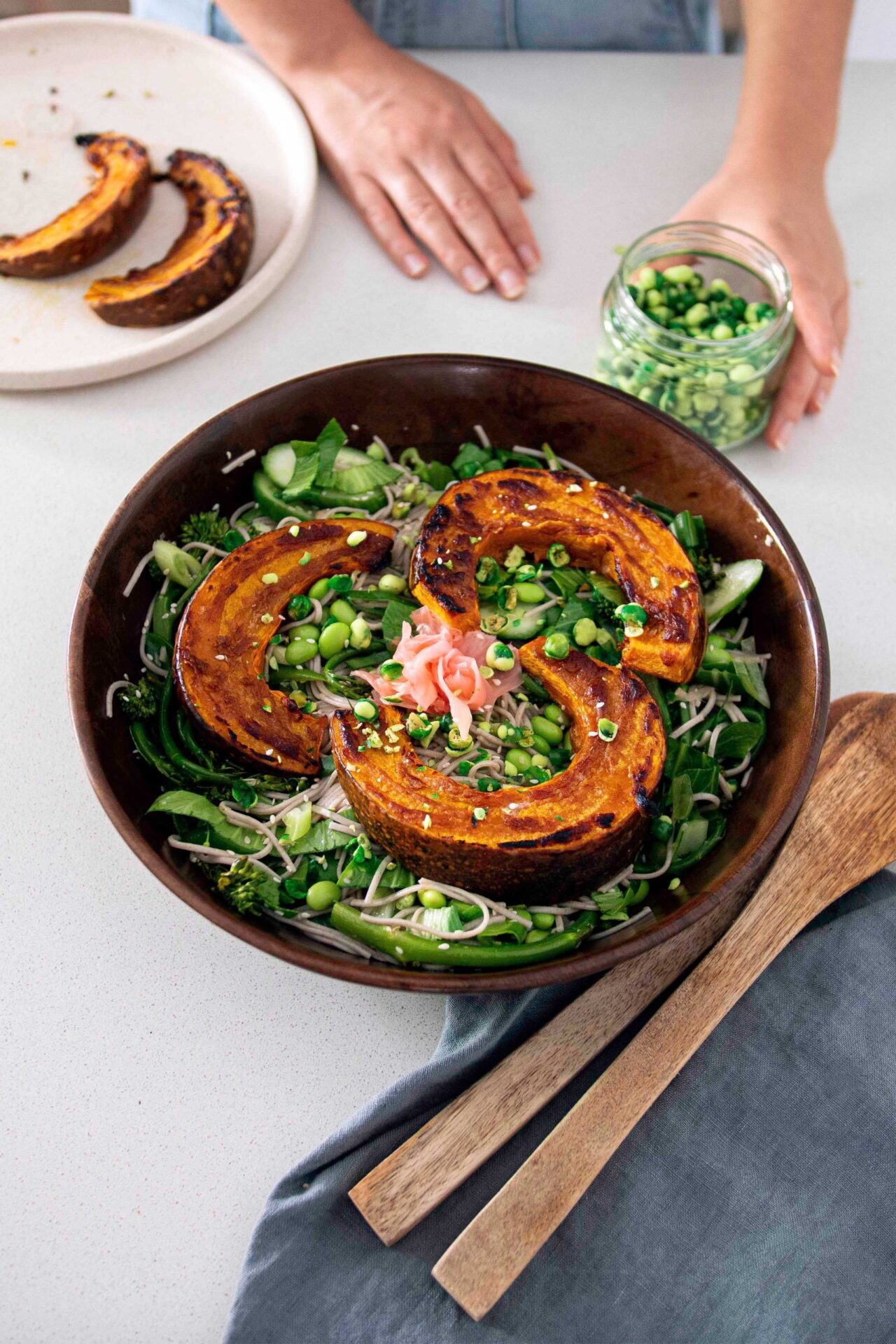 Soba noodle salad with roasted miso pumpkin in a wooden serving bowl