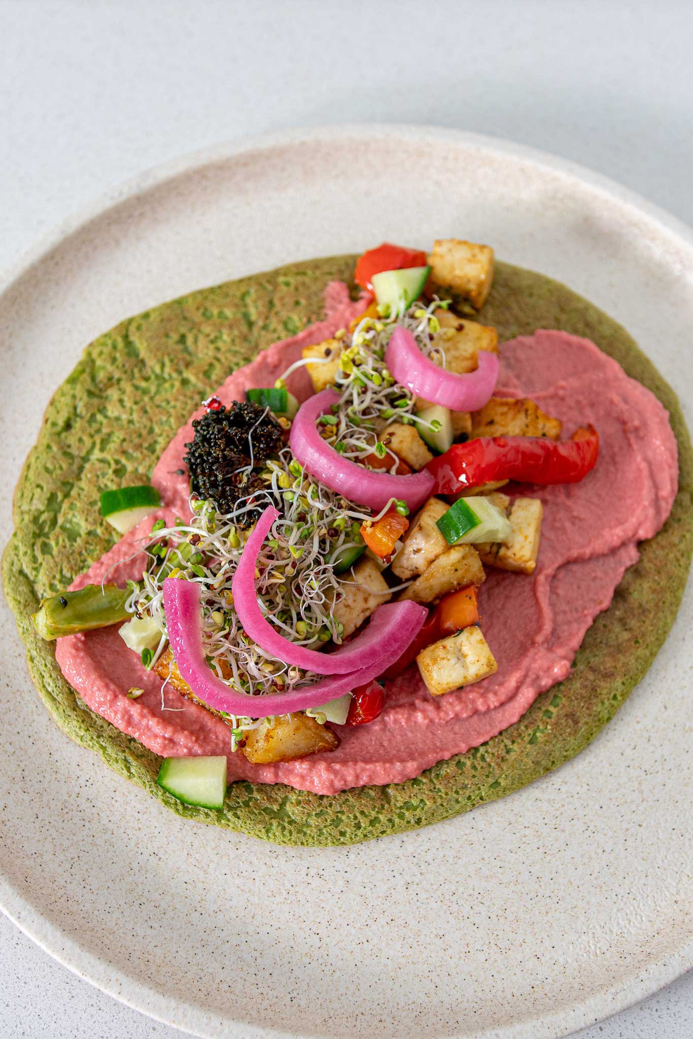 Healthy green spinach wrap with lots of colorful veggies