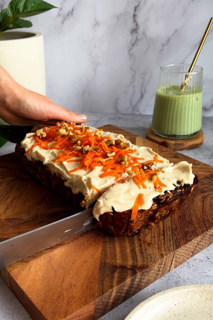 Carrot Cake Baked Oats being cut on a serving board
