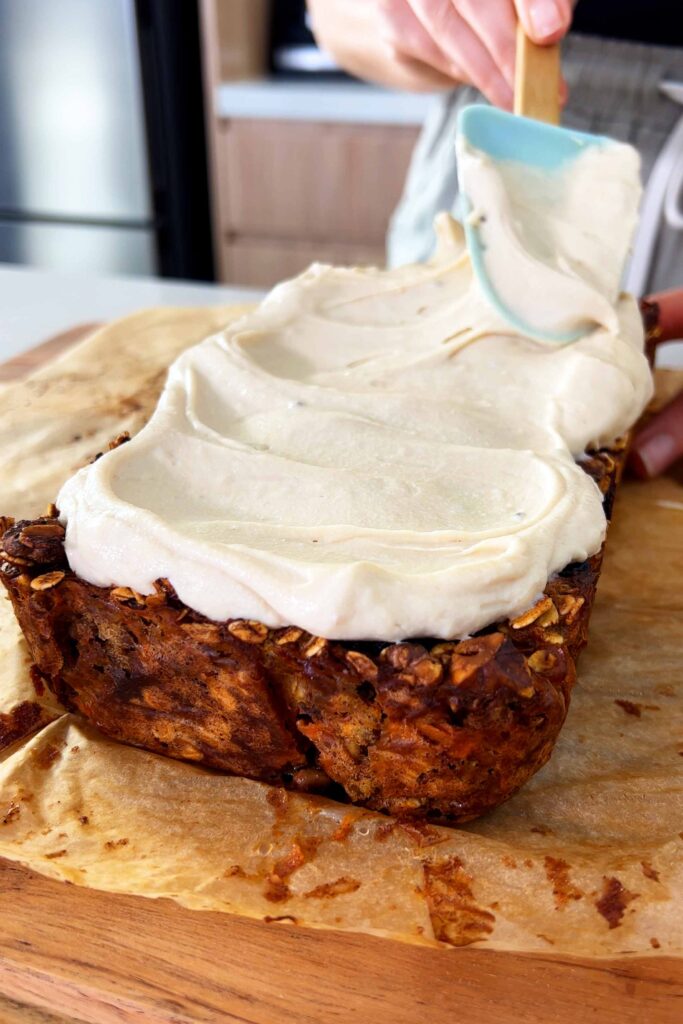 Covering the Carrot Cake Baked Oats with the icing