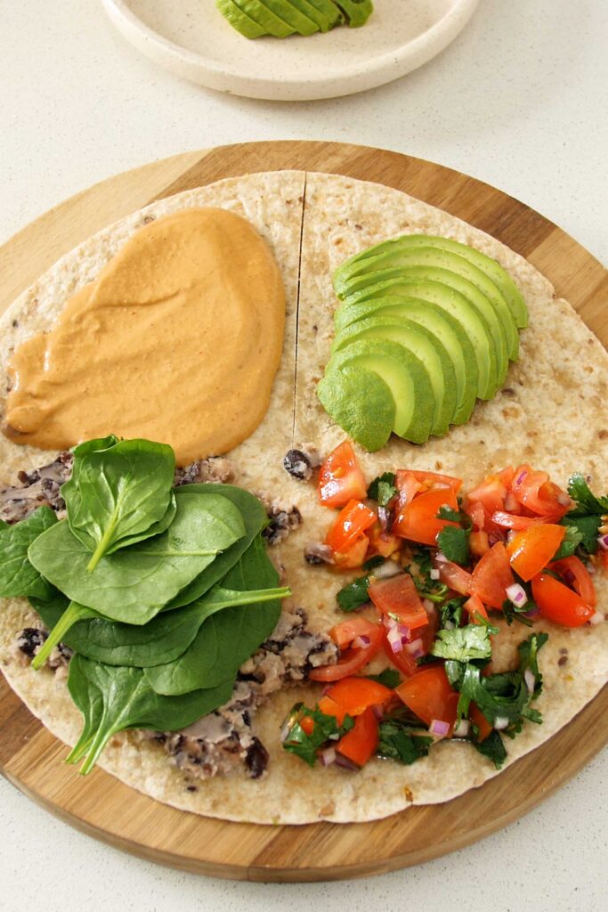 Tortilla wrap with main ingredients in each quadrant plus spinach