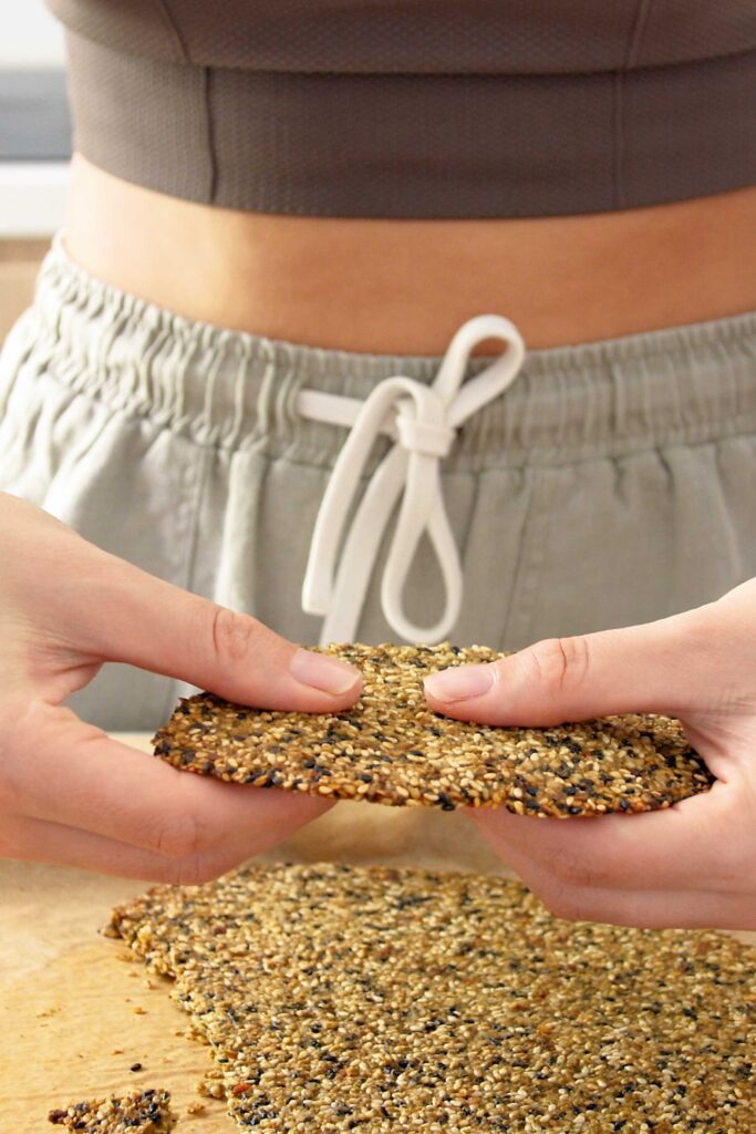 Sarah holding large piece of the baked crackers about to break them apart