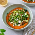 A bowl of vibrant, healthy Zucchini and butter bean salad on a Romanesco-inspired sauce