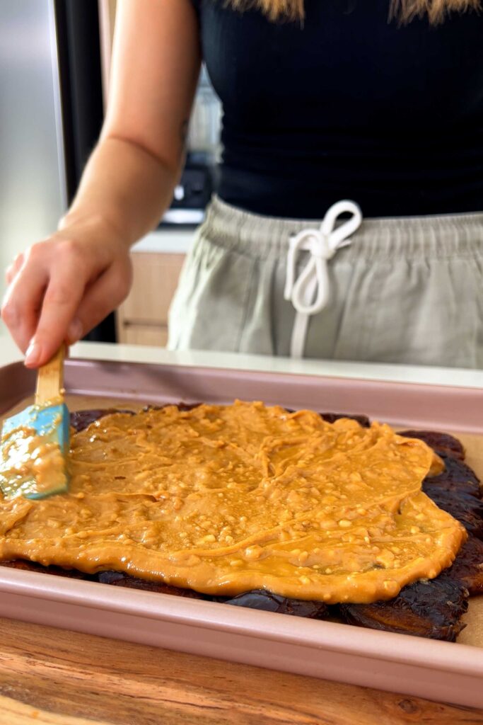 Covering the Medjool dates with a thick layer of peanut butter