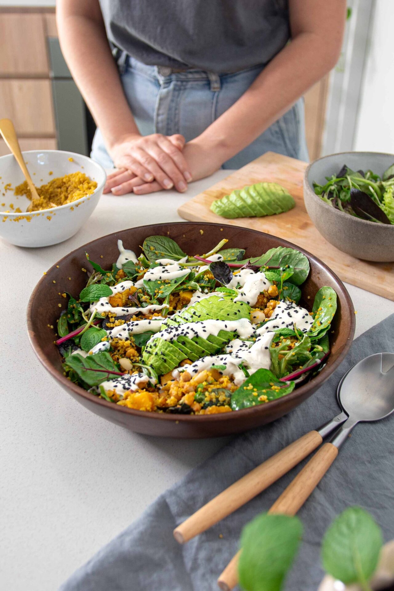 Wooden salad bowl with Roasted Pumpkin, Turmeric Quinoa & Avocado Salad with Tahini Dressing