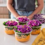 Sarah with the containers of the Romesco Pasta Salad Meal Prep