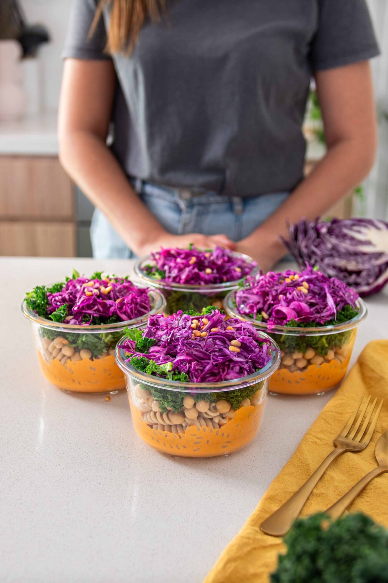 Sarah with the containers of the Romesco Pasta Salad Meal Prep