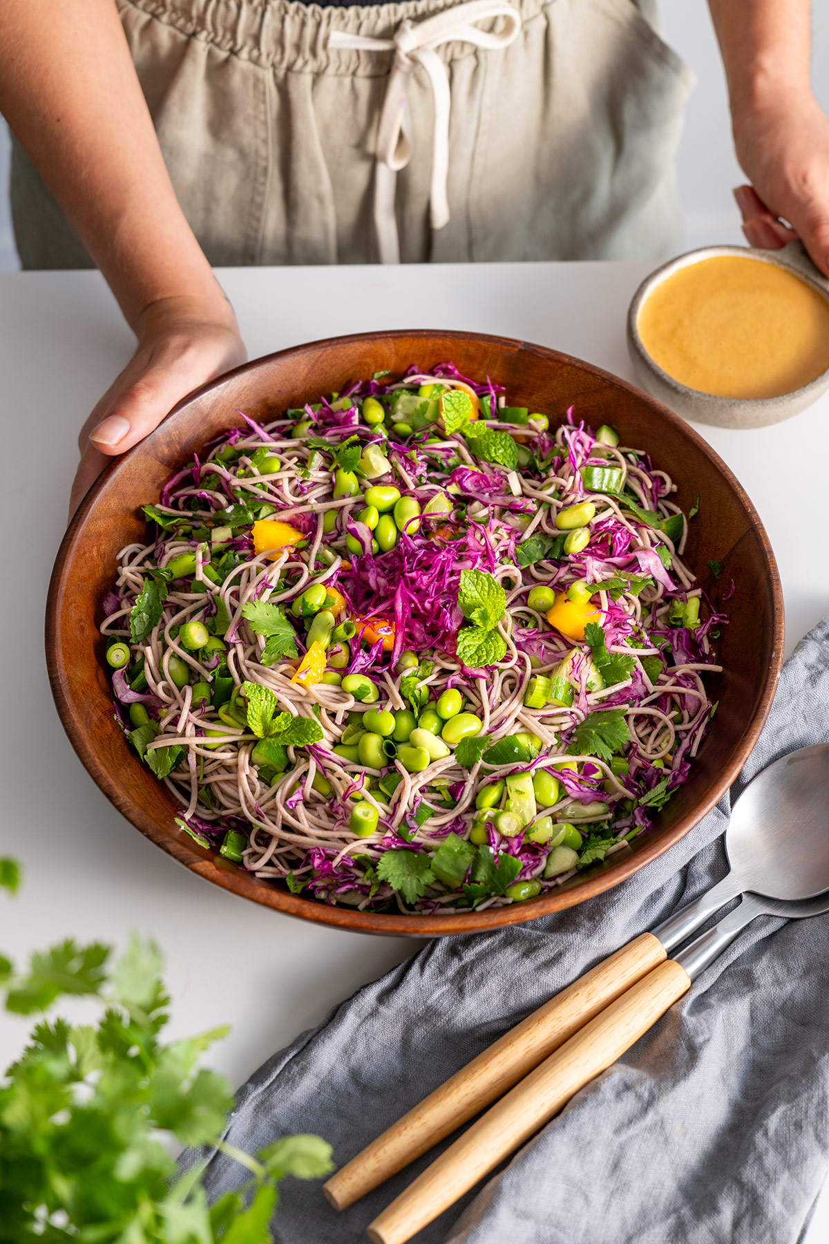 Mixed High Protein Soba Noodle Salad with Peanut Sauce in a wooden bowl, ready to serve.