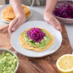 Sarah holding a dish with the Red Lentil Wraps 5 ingredient meal