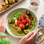 Vibrant, high protein Mediterranean Pesto Bowl with bright green sauce, roasted potatoes and roasted broccoli