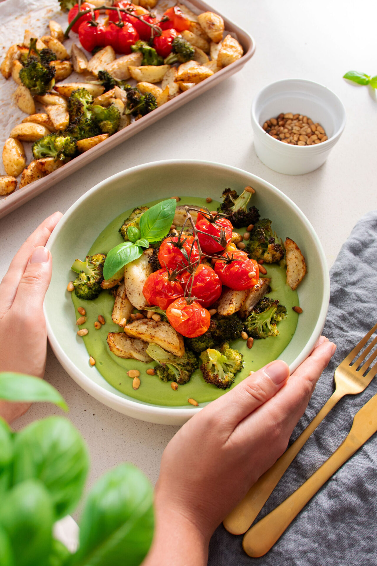 Vibrant, high protein Mediterranean Pesto Bowl with bright green sauce, roasted potatoes and roasted broccoli