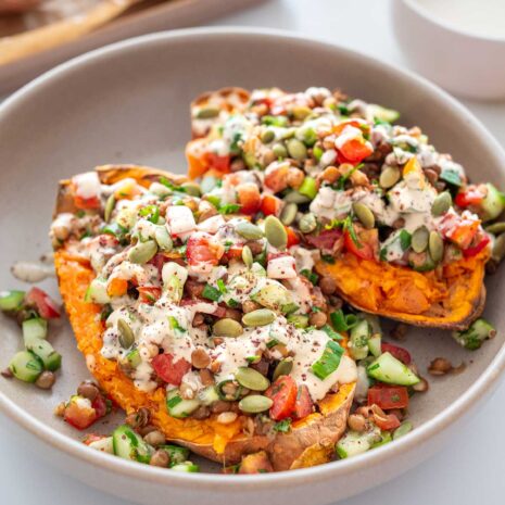 Close-up of Roasted Sweet Potato Tabbouleh Bowl garnished with seeds and dressing