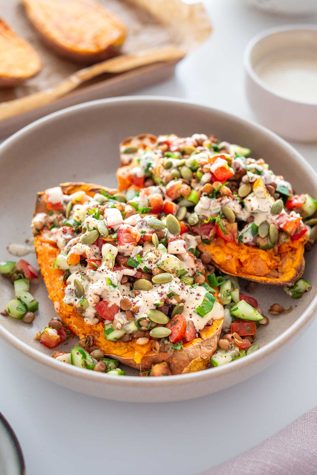 Close-up of Roasted Sweet Potato Tabbouleh Bowl garnished with seeds and dressing