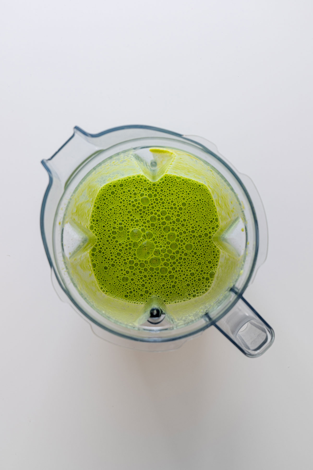 Image of vibrant green buckwheat and spinach batter in a blender, ready for making healthy wraps.