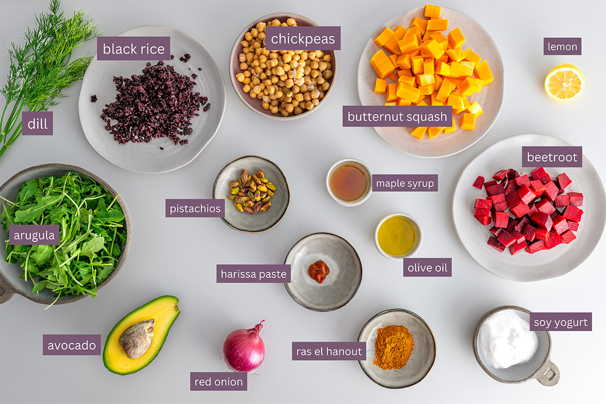 Ingredients for Harissa Pumpkin Salad laid out on a table with ingredient labels.