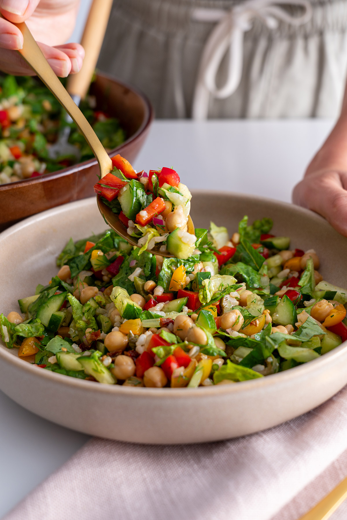 Mediterranean chopped salad served in a bowl, ingredients freshly tossed.