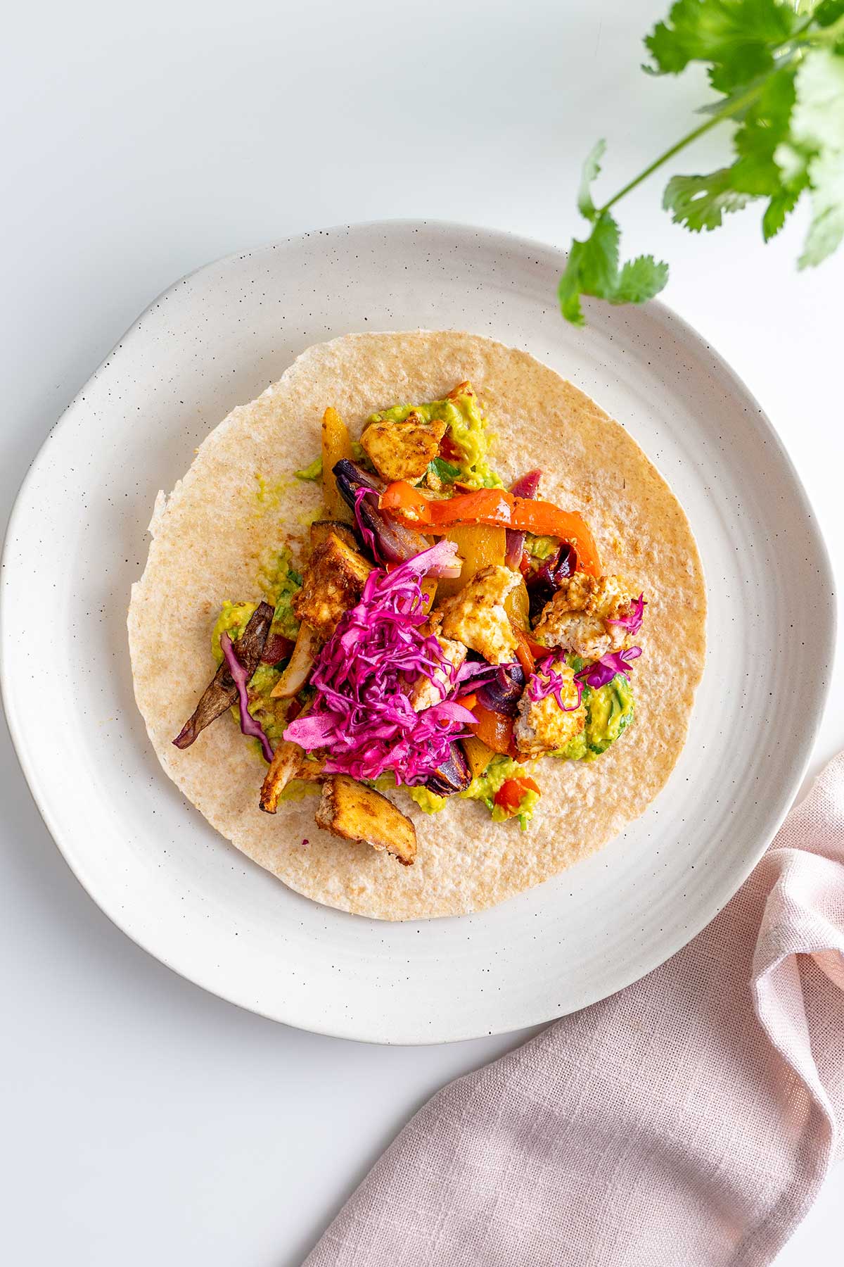 An overhead shot of a fully prepared vegan fajita, open-faced and ready to be enjoyed.