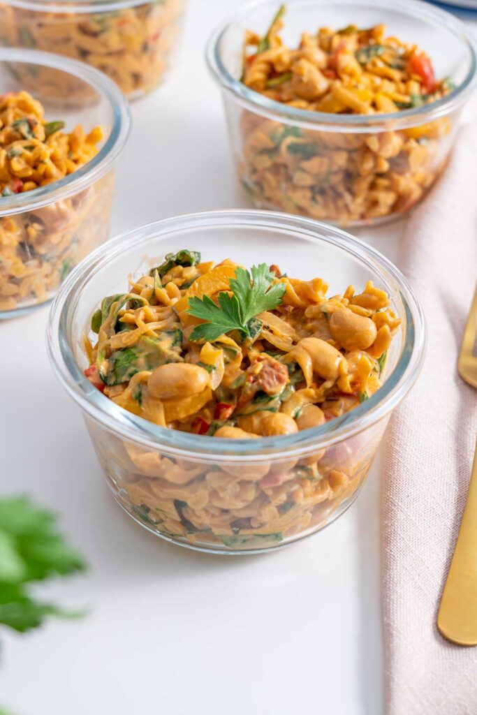 Close-up of a nourishing bowl of 'High-Protein Vegan Marry Me Pasta' with greens and creamy sauce