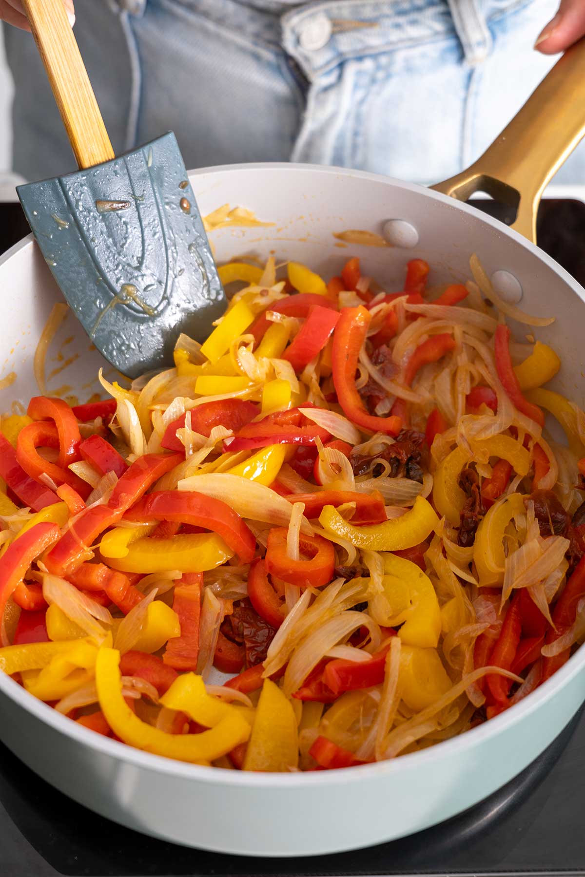 Sautéing mix of red and yellow bell peppers and onions for 'High-Protein Vegan Marry Me Pasta