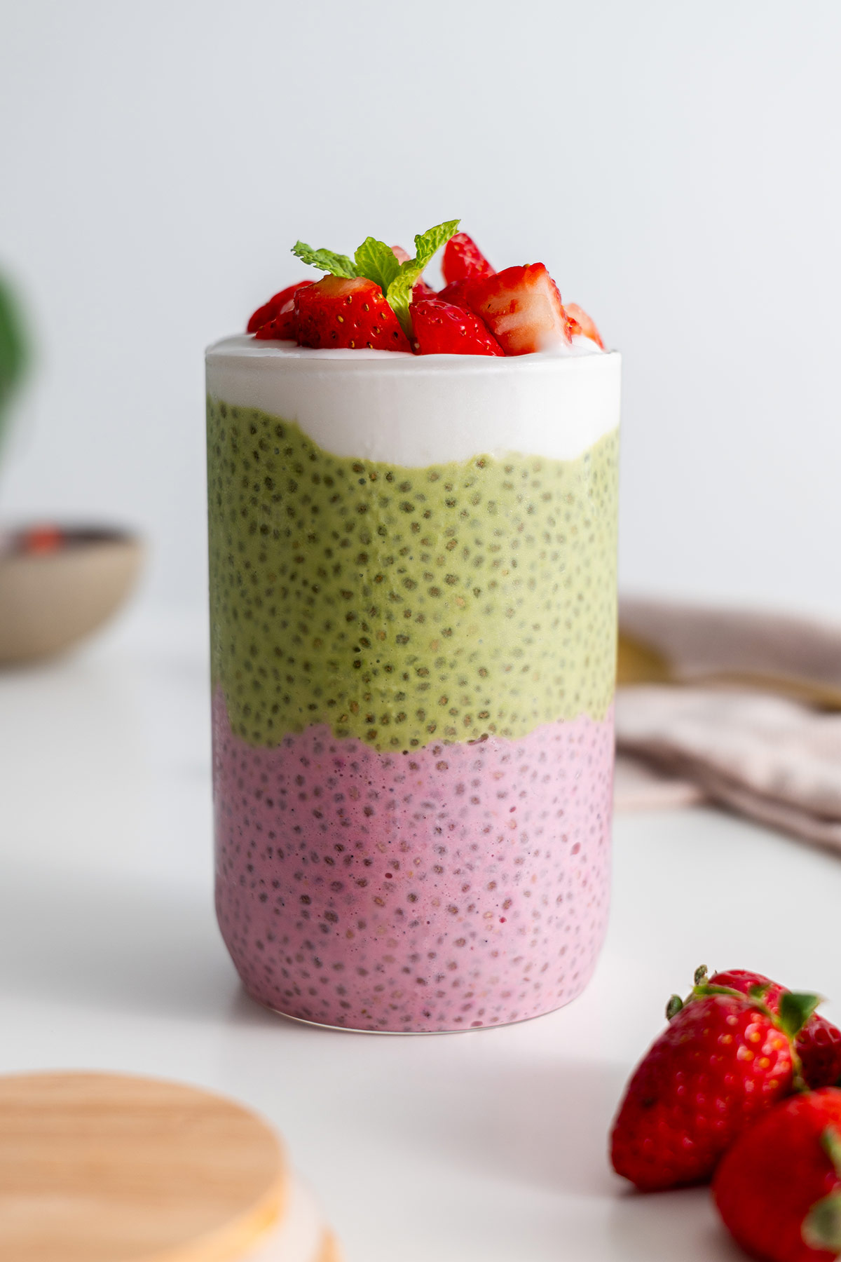 Jar of strawberry matcha chia pudding layered beautifully