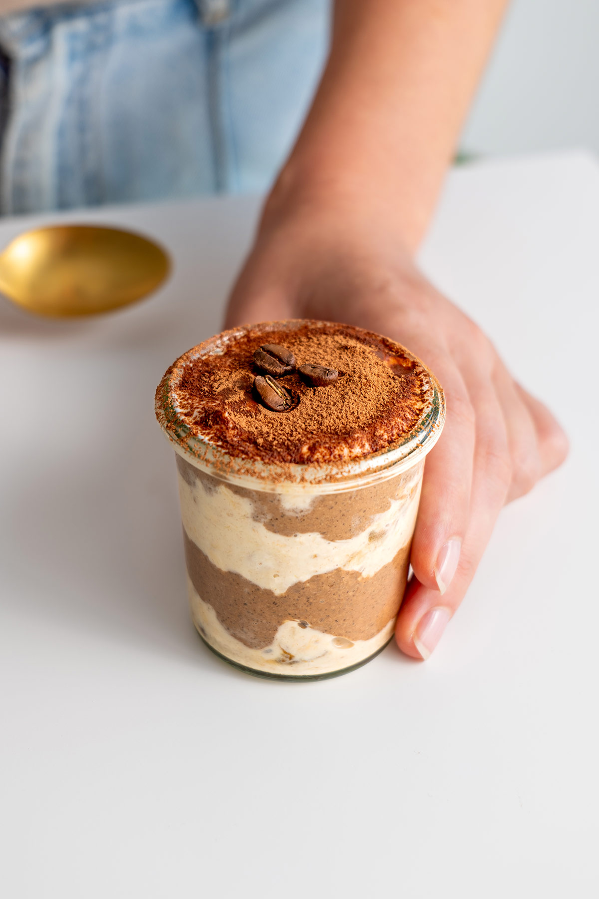 Small glass jar serving of tiramisu overnight oats.