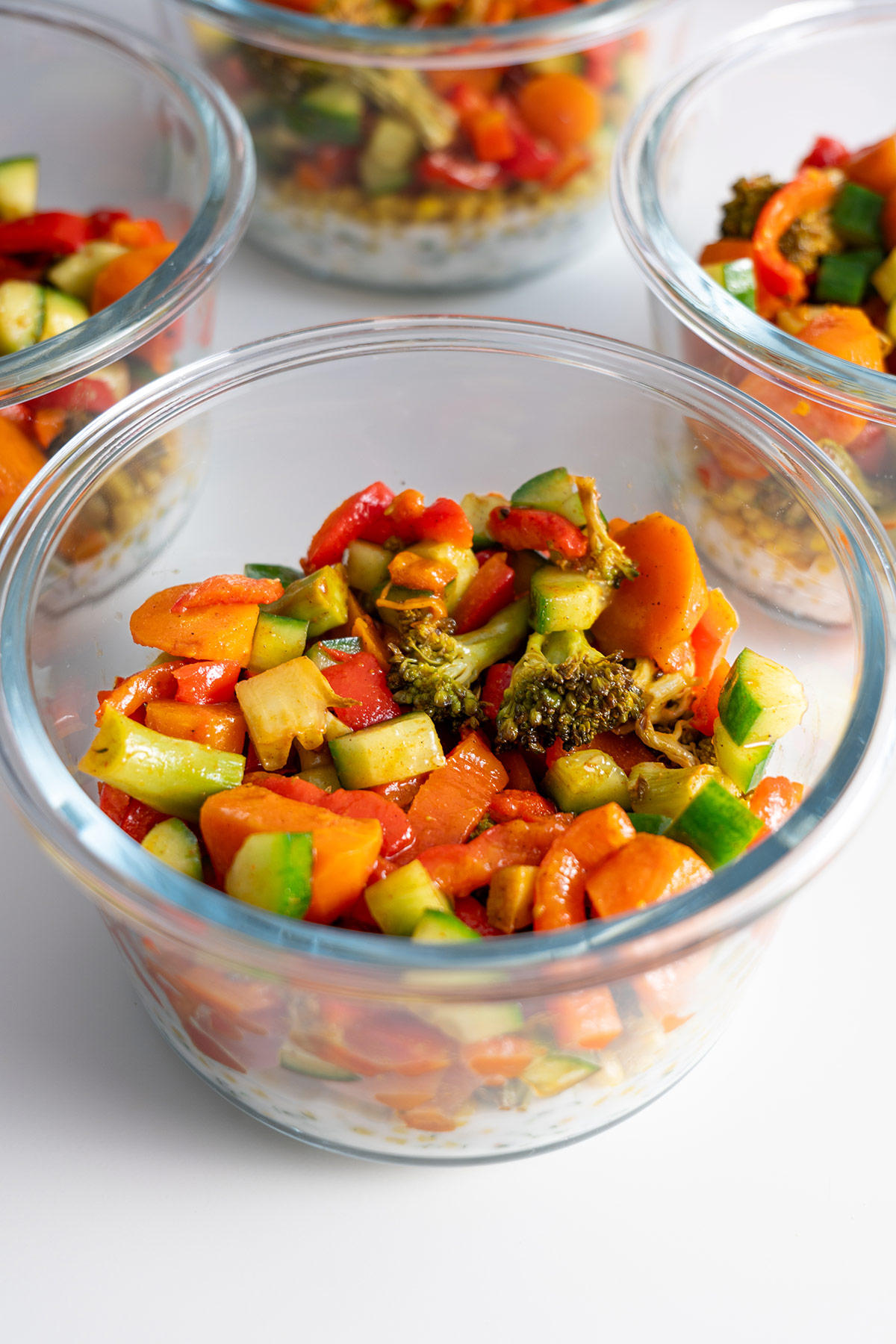 Glass meal prep containers with roasted vegetables.