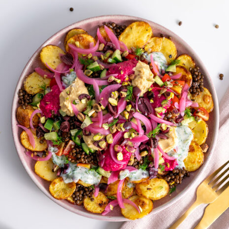 Table setting with Greek-style potato nachos ready to be served.