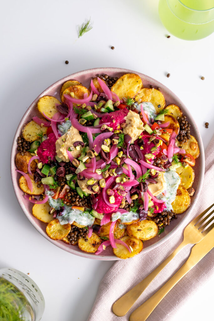Table setting with Greek-style potato nachos ready to be served.